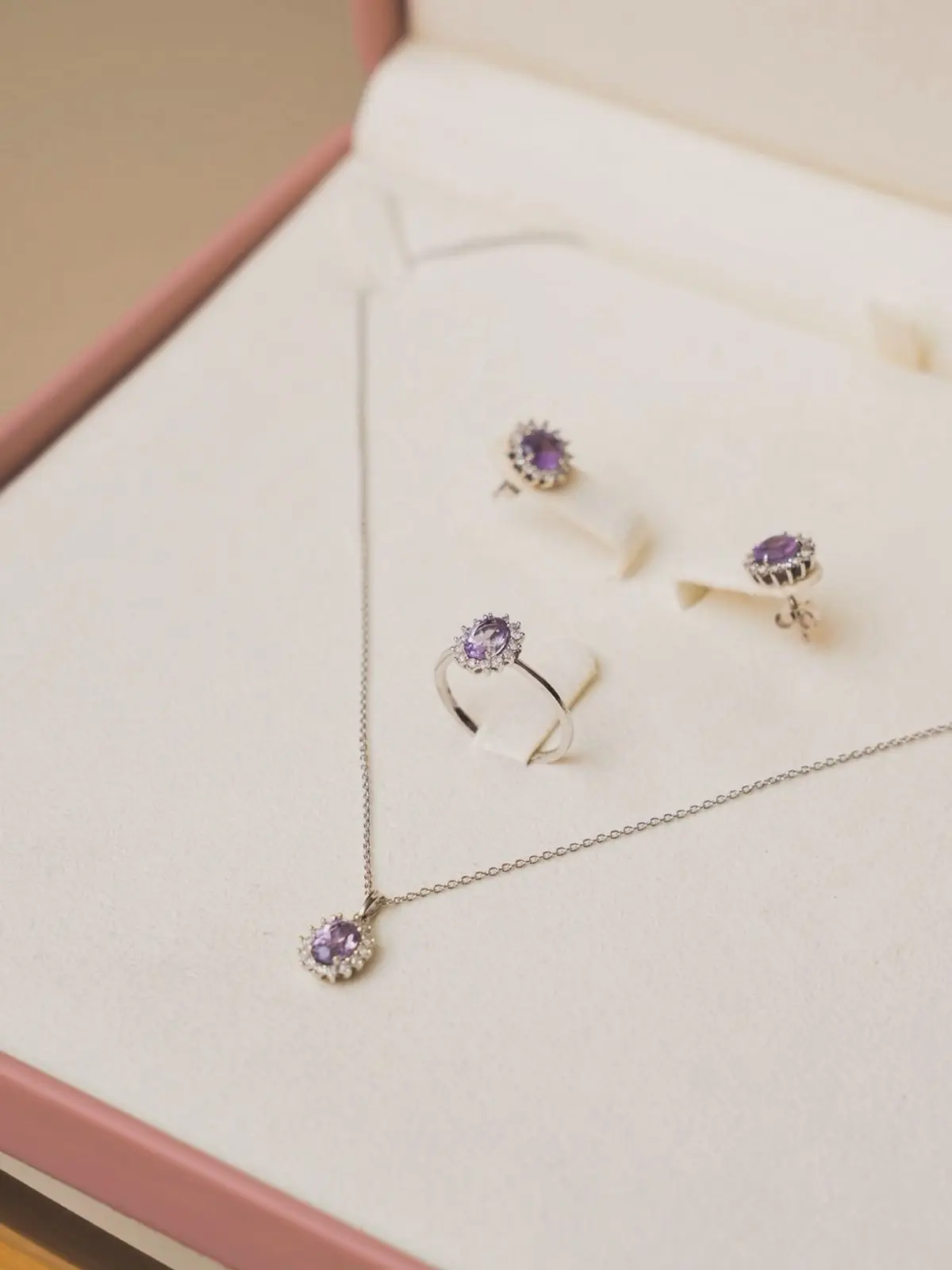Amethyst jewelry set arranged inside a soft pink Diamantea presentation box
